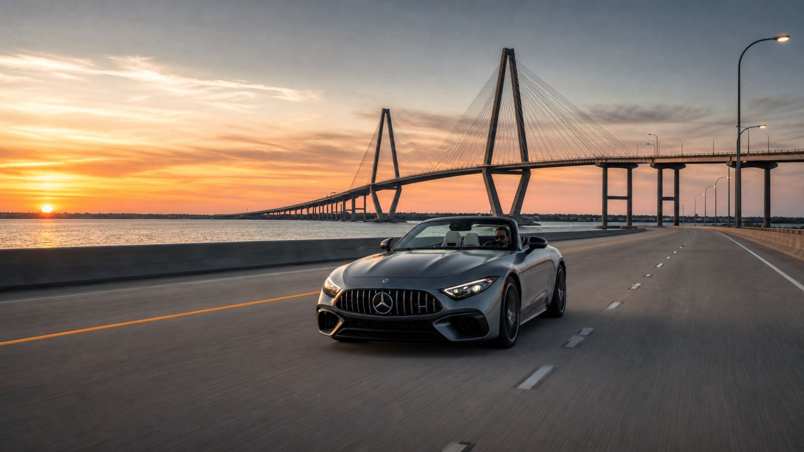 Mercedes-Benz convertible on the Ravenel Bridge near Charleston at sunset